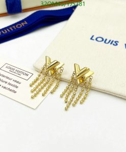 Gold tassel earrings on white surface with brand pouch.