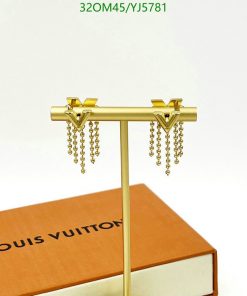 Gold tassel earrings on display stand.