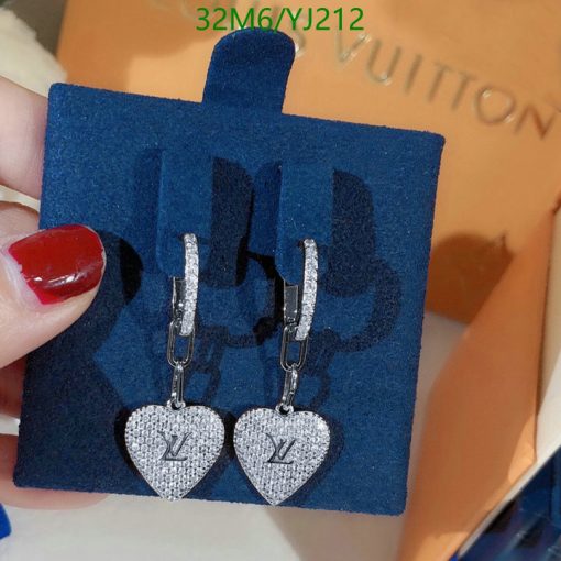 Designer heart-shaped logo earrings on display.