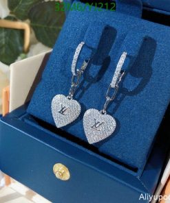 Designer heart-shaped diamond earrings in box.