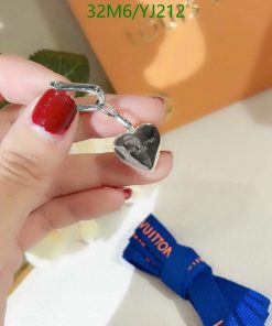 Silver heart-shaped keychain held by hand.