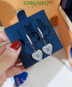 Diamond heart-shaped earrings displayed on blue stand.