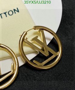 Gold designer logo earrings on card.