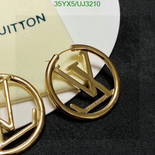 Gold designer logo earrings on card.