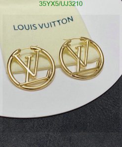 Gold designer logo earrings on card.