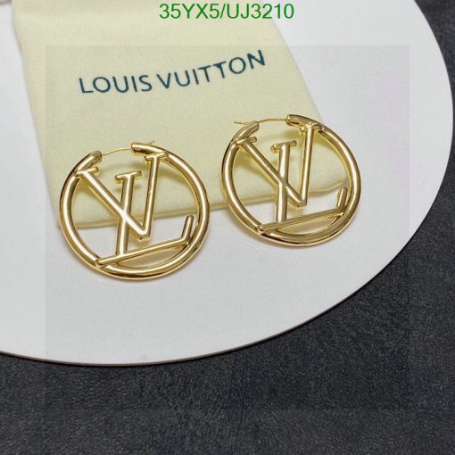 Gold designer logo earrings on card.