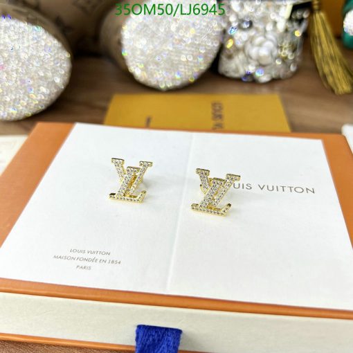 Designer rhinestone earrings on branded display card.