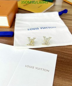 Louis Vuitton branded items on wooden surface.