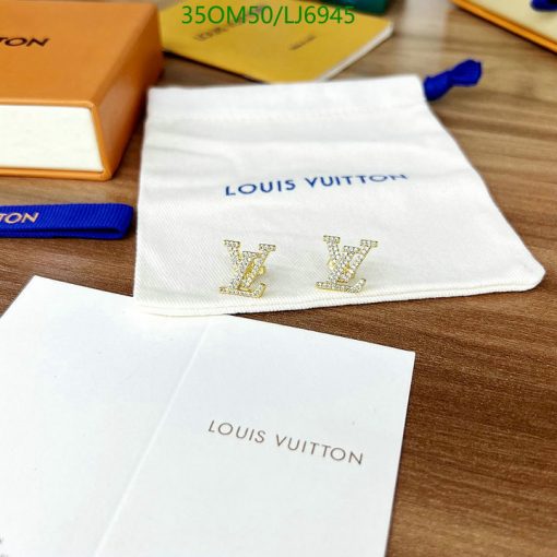 Louis Vuitton branded items on wooden surface.