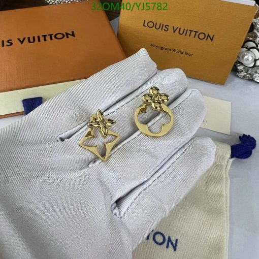 Designer gold earrings on Louis Vuitton packaging.