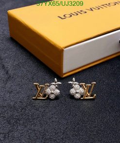 Designer logo earrings with branded box on fabric.