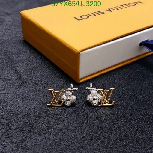 Designer logo earrings with branded box on fabric.