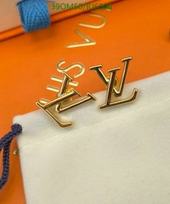 Designer gold-tone cufflinks on white and orange background.