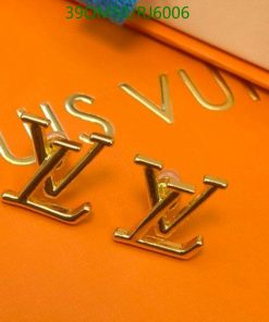 Gold luxury brand initials on orange background.