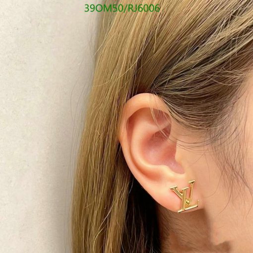 Woman wearing designer logo earring.