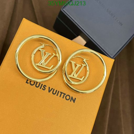 Gold designer logo earrings on branded packaging.