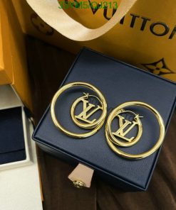 Gold circular designer earrings in a blue box.