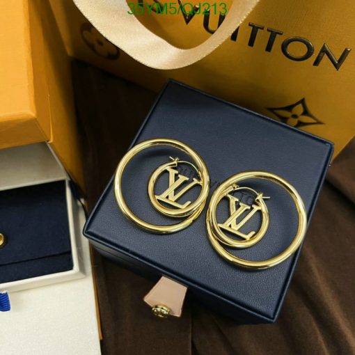 Gold circular designer earrings in a blue box.