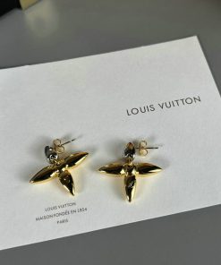 Louis Vuitton gold flower earrings on display.