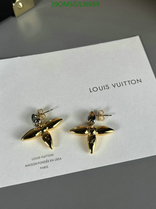 Louis Vuitton gold flower earrings on display.