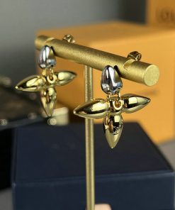 Gold and silver propeller-shaped earrings displayed.