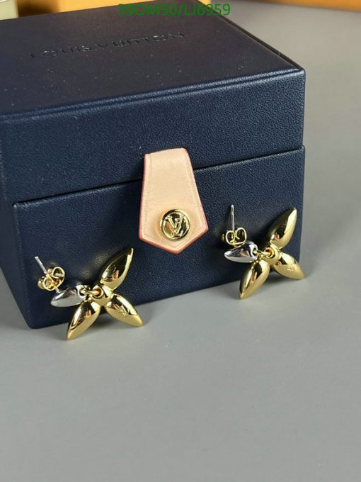 Designer jewelry box with gold-tone flower earrings.