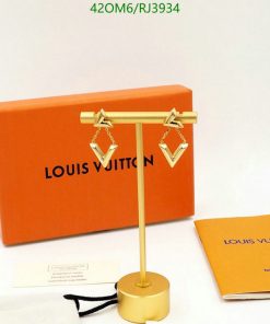 Designer earrings on display with brand packaging.