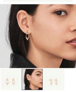 Woman modeling luxury earrings.