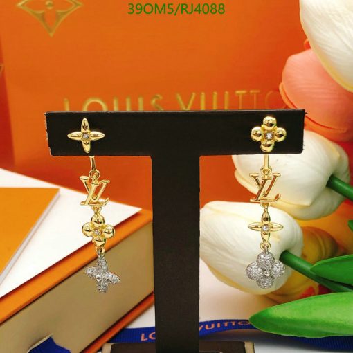 Designer logo drop earrings displayed with packaging.