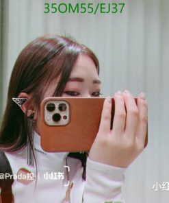 Woman taking selfie with smartphone in mirror.