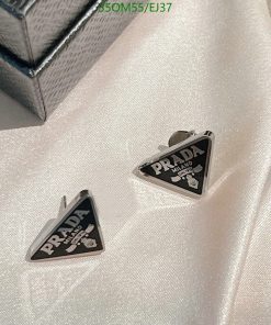 Designer triangle-shaped cufflinks on fabric.