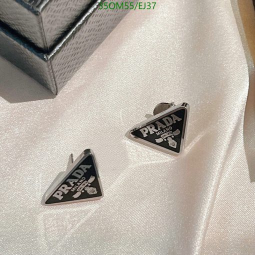 Designer triangle-shaped cufflinks on fabric.