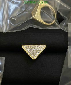 Gold triangle ring with diamonds on black surface.