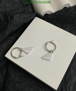 Prada silver triangle logo earrings on white display.