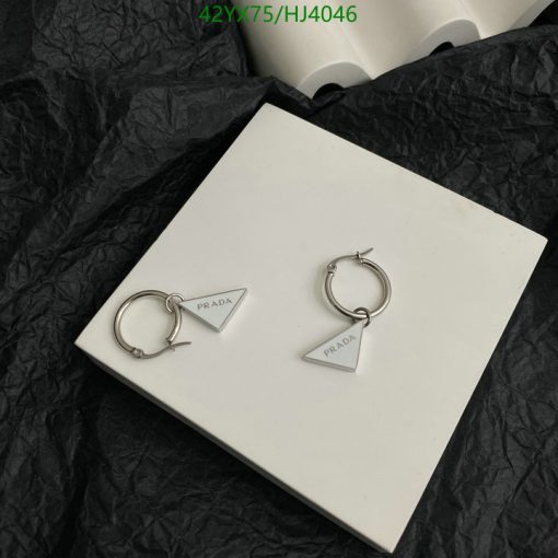 Prada silver triangle logo earrings on white display.