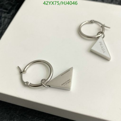 Designer silver triangular hoop earrings on white.