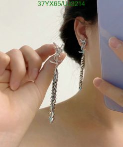 Woman showcasing silver feather earrings.