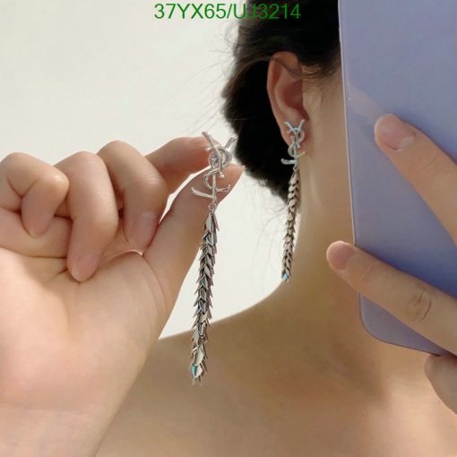 Woman showcasing silver feather earrings.