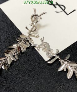 Designer silver leaf motif earrings on card.