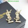 Gold crystal dollar sign earrings on black box.