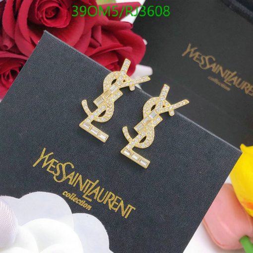 Gold dollar-sign earrings on branded black box.