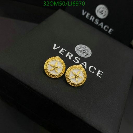 Gold designer cufflinks on branded box.