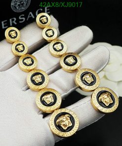 Gold designer buttons on gloved hand.