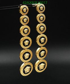 Gold Versace-inspired buttons displayed against a black background.