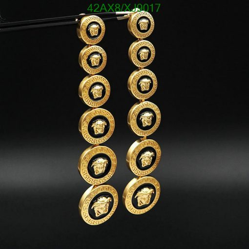 Gold Versace-inspired buttons displayed against a black background.