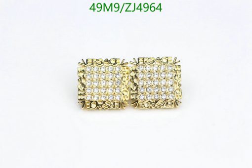 Gold diamond stud earrings on white background.