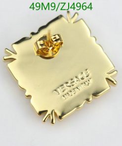 Gold square pin with embossed lettering.