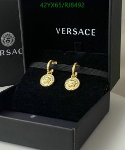 Versace gold medallion earrings displayed in box.