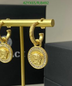 Gold medusa head earrings with diamonds.