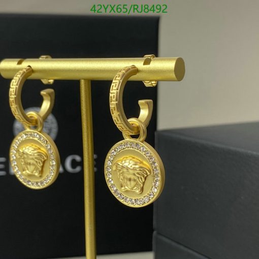 Gold medusa head earrings with diamonds.